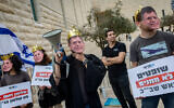 Anti-High Court protesters wear masks of Chief Justice Isaam Amit as he and two other judges hear petitions against the ouster of Shin Bet chief Ronen Bar, in Jerusalem, April 8, 2025. (Yonatan Sindel/Flash90