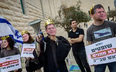 Anti-High Court protesters wear masks of Chief Justice Isaam Amit as he and two other judges hear petitions against the ouster of Shin Bet chief Ronen Bar, in Jerusalem, April 8, 2025. (Yonatan Sindel/Flash90
