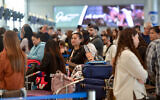 Travelers wait in line at Ben Gurion Airport near Tel Aviv, on April 9, 2025. (Avshalom Sassoni/Flash90)