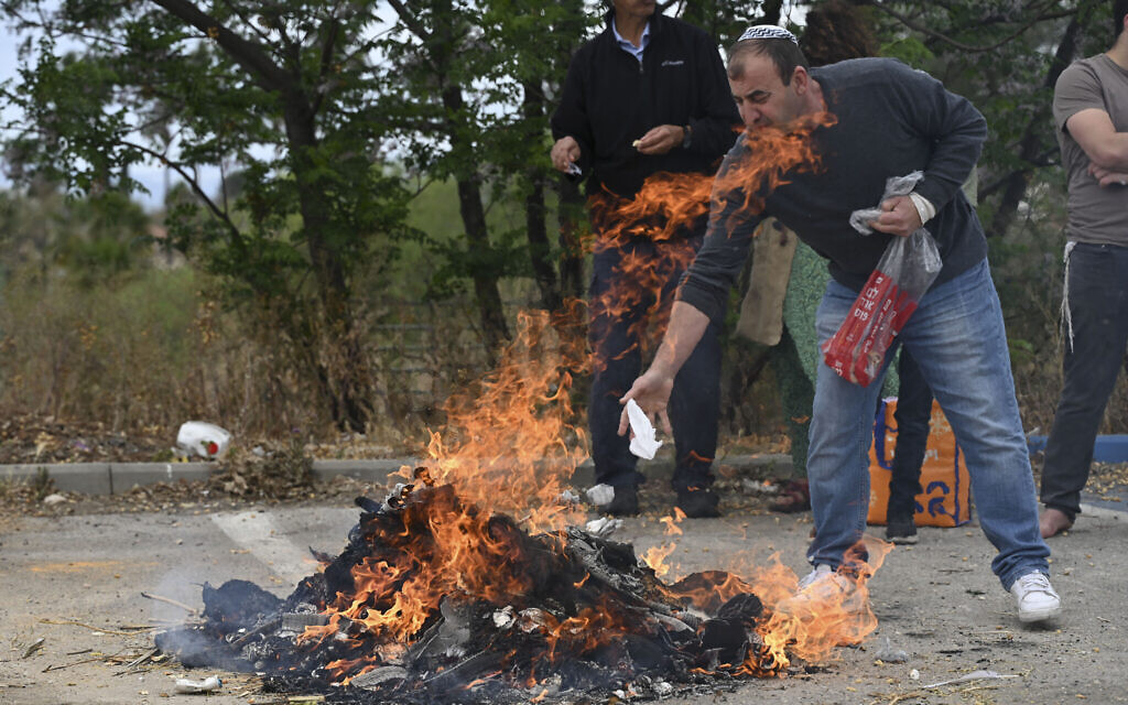Orthodox Jews burn leavened items in a final preparation before the Passover holiday in Katzrin, northern Israel, April 11, 2025. (Michael Giladi/Flash90)