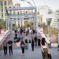 People walk in Eilat on April 10, 2025. (Noam Revkin Fenton/Flash90)