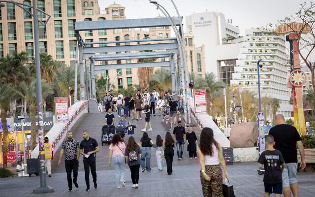 People walk in Eilat on April 10, 2025. (Noam Revkin Fenton/Flash90)