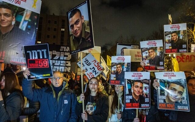 Protesters, led by family members of people held hostage in Gaza, hold placards showing the face of hostage Edan Alexander, near the home of Strategic Affairs Minister Ron Dermer in Jerusalem, on April 13, 2025. (Chaim Goldberg/Flash90) Protesters, led by family members of people held hostage in Gaza, hold placards showing the face of hostage Edan Alexander, near the home of Strategic Affairs Minister Ron Dermer in Jerusalem, on April 13, 2025. (Chaim Goldberg/Flash90)