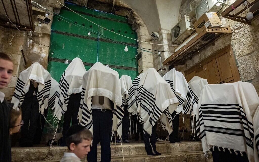 Orthodox Jews pray outside the Temple Mount, in the Muslim Quarter of Jerusalem's Old City, during the Passover holiday, April 17, 2025. (Chaim Goldberg/Flash90)
