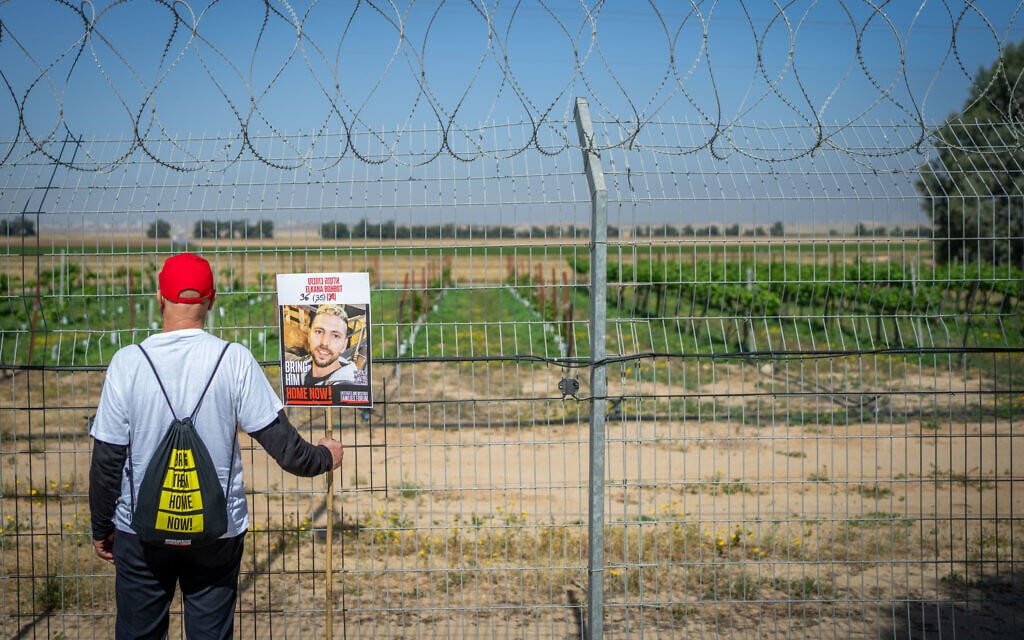 A protester holds a poster of a hostage near the border with Gaza, April 20, 2025. (Erik Marmor/Flash90)