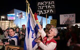 A protest against Prime Minister Benjamin Netanyahu and in support of Shin Bet chief Ronen Bar, as a protestor carries a sign that says, 'Save the country from itself,'  at Habima Square, April 21, 2025 (Photo by Avshalom Sassoni//Flash90)