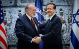 US Ambassador to Israel Mike Huckabee embraces President Isaac Herzog after presenting his credentials, at the President's Residence in Jerusalem, April 21, 2025. (Chaim Goldberg/Flash90)