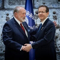 US Ambassador to Israel Mike Huckabee embraces President Isaac Herzog after presenting his credentials, at the President's Residence in Jerusalem, April 21, 2025. (Chaim Goldberg/Flash90)