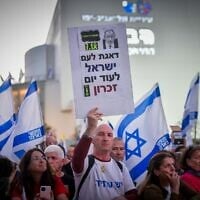 At a protest against Prime Minister Benjamin Netanyahu and his government at Tel Aviv's Habima Square on April 26, 2025, a demonstrator holds a sign that reads 'Concern for the Israeli nation for another Memorial Day' (Photo by Avshalom Sassoni/Flash90)