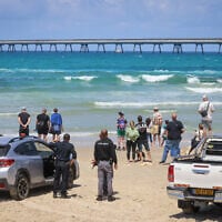 Israelis on the beach in Hadera on April 26, 2025, where a man was attacked and killed by a shark during Passover (Photo by Yossi Zamir/Flash90)