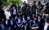Ultra-Orthodox  protesters block the street outside the IDF Recruitment Center at Tel Hashomer, April 28, 2025. (Avshalom Sassoni/Flash90)