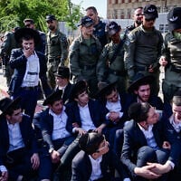 Ultra-Orthodox  protesters block the street outside the IDF Recruitment Center at Tel Hashomer, April 28, 2025. (Avshalom Sassoni/Flash90)