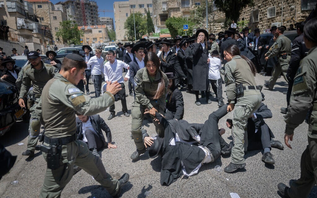 Ultra-Orthodox men protest the IDF draft outside the Jerusalem enlistment center, April 28, 2025 (Chaim Goldberg/Flash90)
