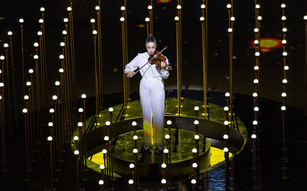 Freed hostage Agam Berger plays the violin at a rehearsal for the 77th Independence Day ceremony, Mount Herzl, Jerusalem, April 28, 2025. A rehearsal for the 77th Independence Day ceremony, filmed at Mount Herzl, Jerusalem, April 28, 2025. The recorded rehearsal for the ceremony was in fact broadcast on the evening of April 30, at the start of Independence Day, in place of the intended live event, which was canceled because of wildfires raging around Jerusalem. (Yonatan Sindel/Flash90)