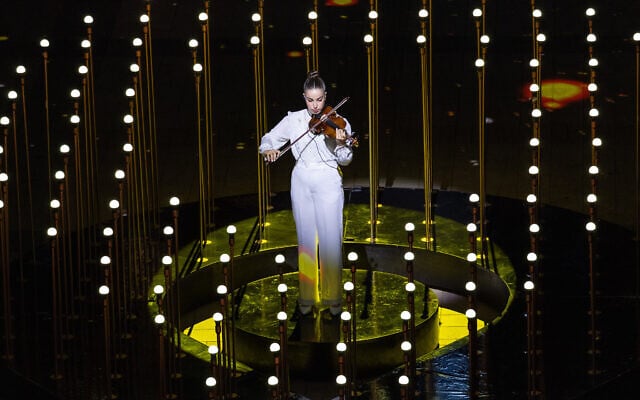 Freed hostage Agam Berger plays the violin at a rehearsal for the 77th Independence Day ceremony, Mount Herzl, Jerusalem, April 28, 2025. A rehearsal for the 77th Independence Day ceremony, filmed at Mount Herzl, Jerusalem, April 28, 2025. The recorded rehearsal for the ceremony was in fact broadcast on the evening of April 30, at the start of Independence Day, in place of the intended live event, which was canceled because of wildfires raging around Jerusalem. (Yonatan Sindel/Flash90)