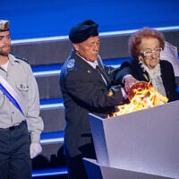 Blanca Gut and Itzik Akrish light the torch during the main rehearsal of the 77th anniversary Independence Day ceremony, held at Mount Herzl, Jerusalem, on April 28, 2025.(Yonatan Sindel/Flash90)