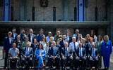 Most of this year's Independence Day torch-lighters pose for a photo outside the Knesset with Knesset Speaker Amir Ohana and Transportation Minister Miri Regev, April 28, 2025. (Yonatan Sindel/Flash90)