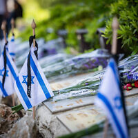 Israeli flags on graves of fallen soldiers in Mount Herzl Military Cemetery in Jerusalem, on April 29, 2025, ahead of Israeli Memorial Day. (Chaim Goldberg/Flash90)