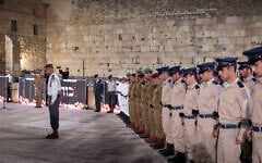 Israeli soldiers stand still as the memorial siren sounds during the ceremony marking Memorial Day for Israel's fallen soldiers and victims of terror, at the Western Wall in Jerusalem's Old City, on April 29, 2025. (Chaim Goldberg/Flash90)