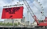 A temporary billboard displayed by Nike, meant to inspire runners in the 2025 London Marathon, reads 'Never again. Until next year,' April 27, 2025. (Via X via JTA)
