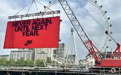 A temporary billboard displayed by Nike, meant to inspire runners in the 2025 London Marathon, reads 'Never again. Until next year,' April 27, 2025. (Via X via JTA)