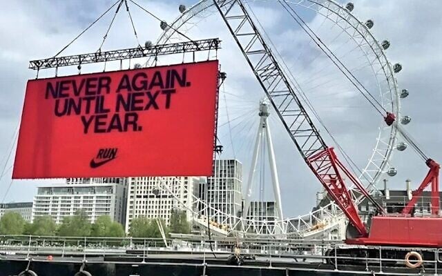 A temporary billboard displayed by Nike, meant to inspire runners in the 2025 London Marathon, reads 'Never again. Until next year,' April 27, 2025. (Via X via JTA)