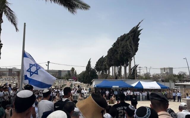 Israelis gather in the Kiryat Gat military cemetery for the city’s annual Memorial Day ceremony, April 30, 2025. (Stav Levaton/Times of Israel)