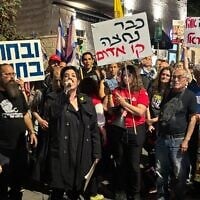 Noam Dan, a relative of freed hostage Ofer Calderon, speaks to protesters outside Prime Minister Benjamin Netanyahu's private residence in Jerusalem on April 17, 2025. (Charlie Summers/Times of Israel)