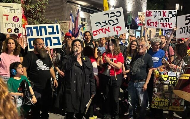 Noam Dan, a relative of freed hostage Ofer Calderon, speaks to protesters outside Prime Minister Benjamin Netanyahu's private residence in Jerusalem on April 17, 2025. (Charlie Summers/Times of Israel) Noam Dan, a relative of freed hostage Ofer Calderon, speaks to protesters outside Prime Minister Benjamin Netanyahu's private residence in Jerusalem on April 17, 2025. (Charlie Summers/Times of Israel)