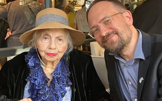 Rita Krasimow, left, the runner-up in the 2018 Miss Holocaust survivor beauty pageant, and one of the main protagonists in "Miss Holocaust Survivor," sits with film director Radek Wegrzyn at the screening of the film in Haifa on April 22, 2025. (Diana Bletter/Times of Israel)