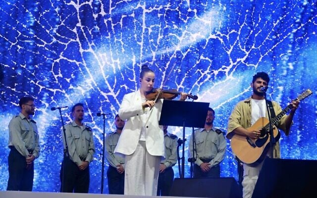 Released hostage Agam Berger and Kibbutz Be’eri survivor Daniel Weiss perform at March of the Living on April 24, 2025. (Yosi Zeleger/March of the Living)