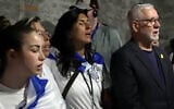 Bereaved Israelis, relatives of hostages and released hostages sing 'Hatikvah' at Auschwitz, April 23, 2025 (Channel 12 screenshot)