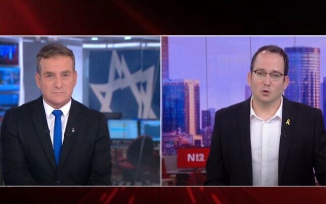 Channel 12 news anchor Danny Kushmaro (left), announcing on air that the station's Neve Ilan studio is being evacuated because of an approaching wildfire, hands over the TV news broadcast to colleague Liron Zaid at an "alternative studio" in Herzliya, April 30, 2025. (Screenshot)