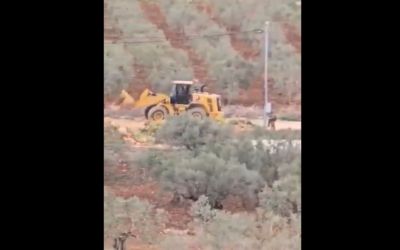 Screenshot of footage posted by Yesh Din showing settlers using a bulldozer to set up an illegal outpost near Turmusaya, West Bank, April 18, 2025. (Yesh Din English / X)