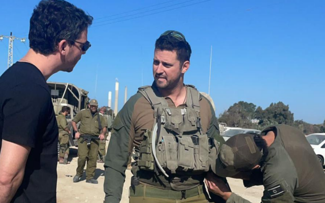 By chance, reserve combat paramedic David Citron (middle) runs into decade-long friend Alan Buch, a New York-based venture capitalist, at the Zikim crossing bordering the Gaza Strip, in December 2023. (Courtesy)