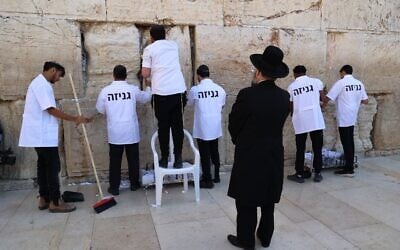 Staff from the Western Wall Heritage Foundation remove notes and messages from the Western Wall ahead of the Jewish holiday of Passover on April 2, 2025. (Western Wall Heritage Foundation)
