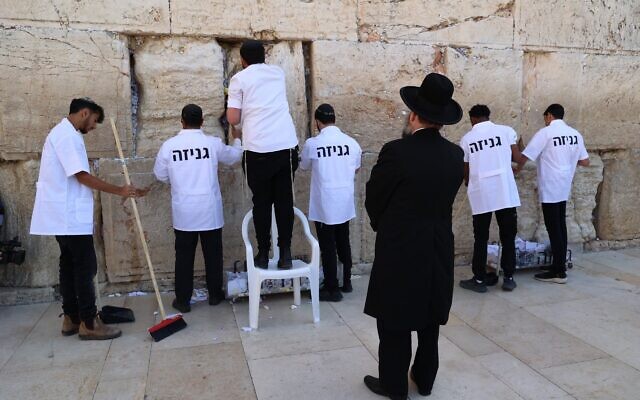 Staff from the Western Wall Heritage Foundation remove notes and messages from the Western Wall ahead of the Jewish holiday of Passover on April 2, 2025. (Western Wall Heritage Foundation)
