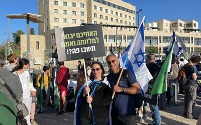 Sylvie and Yinon Tsuriely join a march in Jerusalem demanding universal enlistment in the IDF promoted by bereaved families and leading reservist organizations on April 2, 2025. (Rossella Tercatin/Times of Israel)