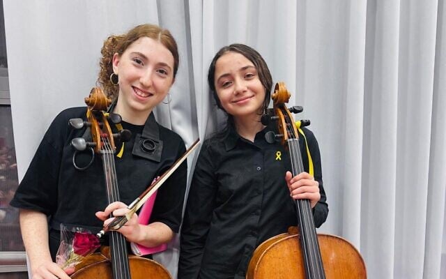 Two members of the Lu Yehi Orchestra in Jerusalem on April 8, 2025 (Courtesy)