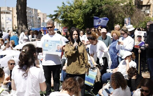 Anat Angrest, mother of Matan Angrest, a soldier still being held captive by Hamas, wears Matan's uniform as she speaks to the crowd at a Shift 101 protest in the northern town of Kiryat Motzkin. (Amir Yarchi/Pro-Democracy Protest Movement) Anat Angrest, mother of Matan Angrest, a soldier still being held captive by Hamas, wears Matan's uniform as she speaks to the crowd at a Shift 101 protest in the northern town of Kiryat Motzkin. (Amir Yarchi/Pro-Democracy Protest Movement)