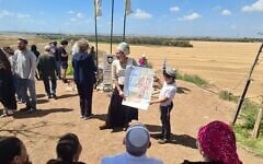Arbel Zak, a senior Nachala leader, holds a map of envisioned settlements inside Gaza, at the Nahal Oz soldiers memorial overlooking Gaza, April 15, 2025. (Deborah Danan via JTA)
