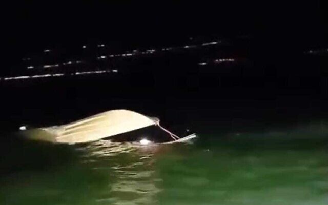 A boat that had been carrying four people sinks in the Sea of Galilee after police rescue its passengers on April 16, 2025. (Israel Police)