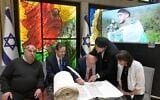 President Isaac Herzog hosts a ceremony marking the completion of a Torah scroll dedicated to Sgt. Segev Schwartz, 20, who was killed in battle on October 7, 2023, ahead of Memorial Day in April 2025. His parents, Sarah and Ehud, are seated to the left and to the right. (Courtesy of Ayelet HaShachar)