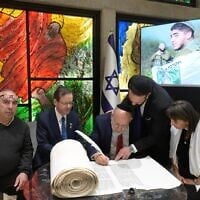 President Isaac Herzog hosts a ceremony marking the completion of a Torah scroll dedicated to Sgt. Segev Schwartz, 20, who was killed in battle on October 7, 2023, ahead of Memorial Day in April 2025. His parents, Sarah and Ehud, are seated to the left and to the right. (Courtesy of Ayelet HaShachar)