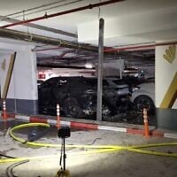 A burnt out car thought to have exploded, killing a man in a parking lot in Beersheba on April 29, 2025. (Fire and Rescue Service)