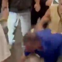 An employee of Egged is attacked by a group at the Jerusalem Central Bus Station on April 20, 2025 (Screen grab from video used in accordance with Clause 27a of the Copyright Law)