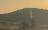 Footage shows a man identified as a settlement security coordinator shooting in the air during a confrontation with Palestinians in the South Hebron Hills on April 17, 2025. (Screen capture: Asya Elias)