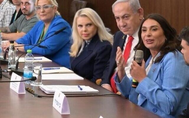 Prime Minister Benjamin Netanyahu, 2nd right, his wife Sara Netanyahu, 2nd left, and Transportation Minister Miri Regev, far right, meet with slated Independence Day torch-bearers at the Prime Minister's Office in Jerusalem, April 28, 2025. (Amos Ben Gershon / GPO)