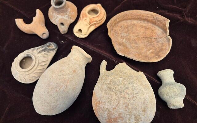 Looted artifacts seized at the house of a Dimona resident suspected of illegal antiquities trafficking on April 21, 2025. (Yoli Schwartz/Israel Antiquities Authority)