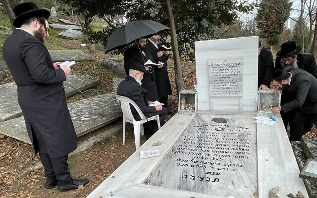 Ultra-Orthodox pilgrims pray at the grave of Rabbi Naphtali Hakohen Katz, a 17th-century Kabbalist, in the Ortakoy neighborhood of Istanbul, Turkey, January 17, 2023. (David I. Klein/JTA) Ultra-Orthodox pilgrims pray at the grave of Rabbi Naphtali Hakohen Katz, a 17th-century Kabbalist, in the Ortakoy neighborhood of Istanbul, Turkey, January 17, 2023. (David I. Klein/JTA)